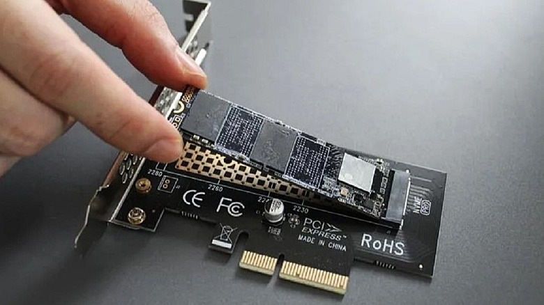 Close-up of a Glotrends PA09-HS M.2 NVMe to PCIe 4.0 X4 adapter being slotted into a motherboard.