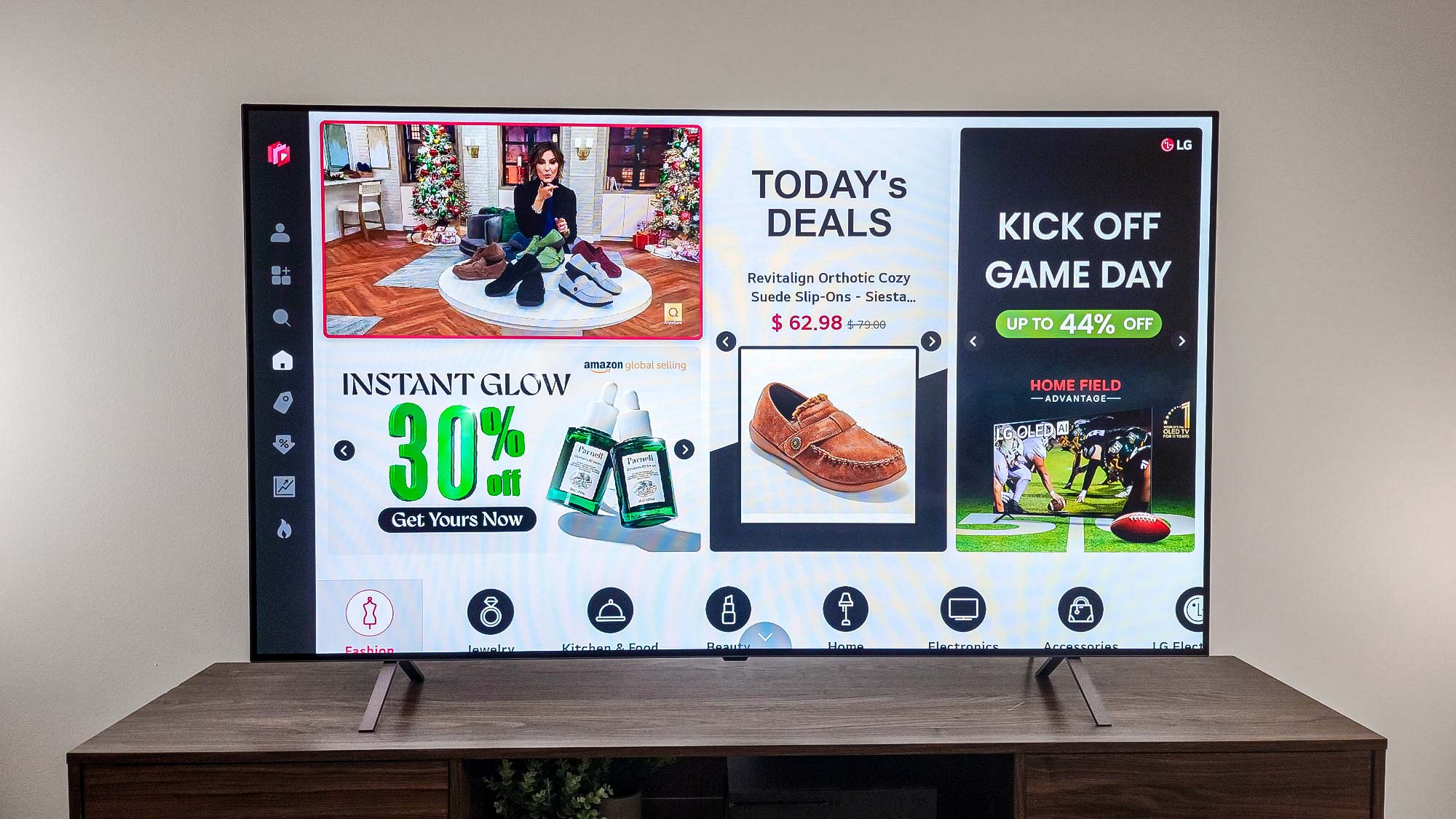 LG B4 OLED TV angled on a tabletop stand in a bright room.