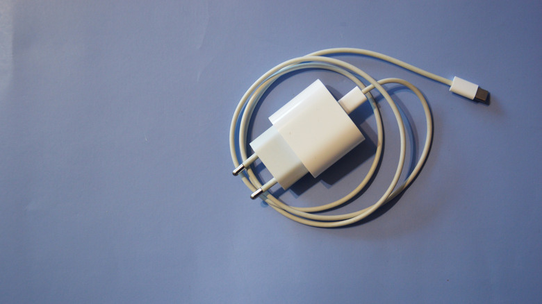 A white wall charger on a blue background.