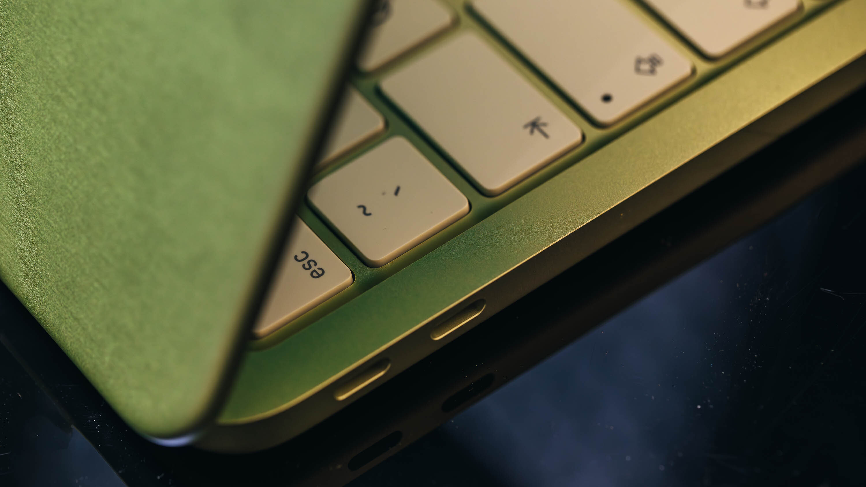 Side profile view of the thin MacBook Neo laptop.