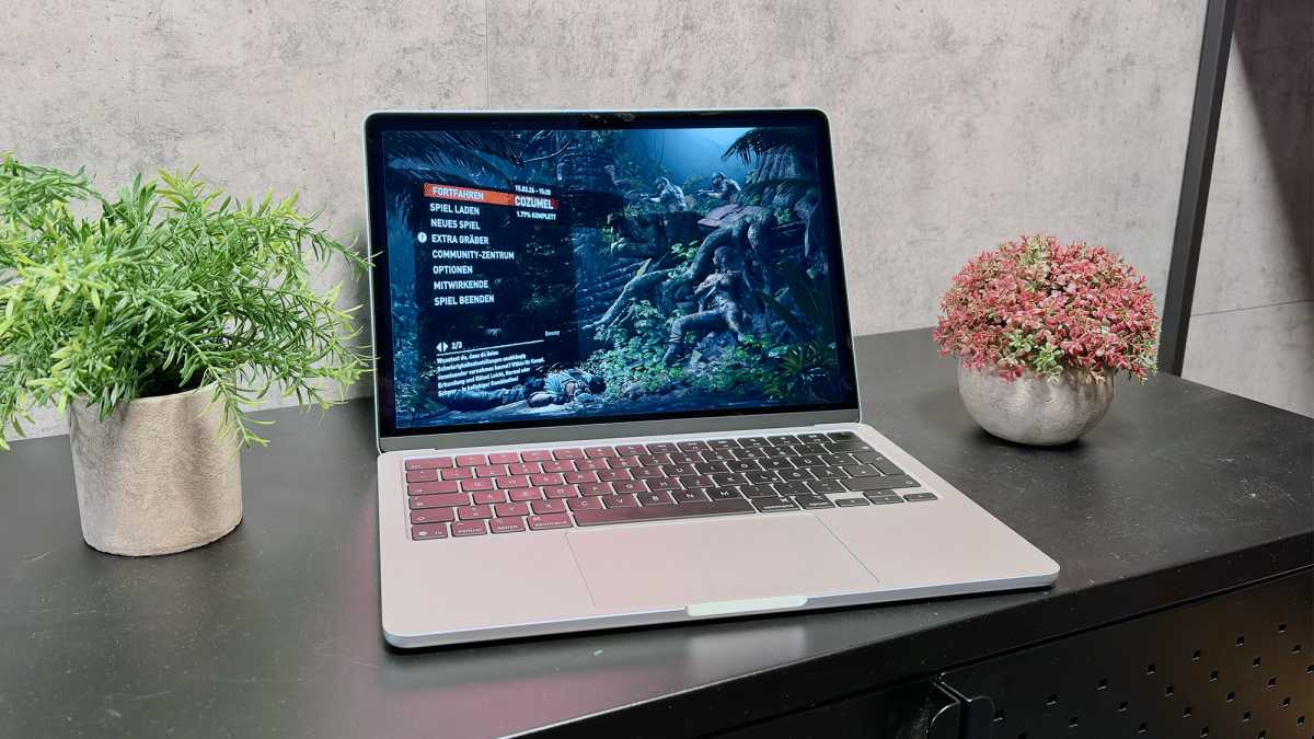 A silver 13-inch M5 MacBook Air sitting on a modern office desk.