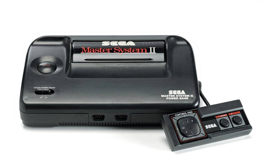 A Sega Master System console with its black and red themed controller.