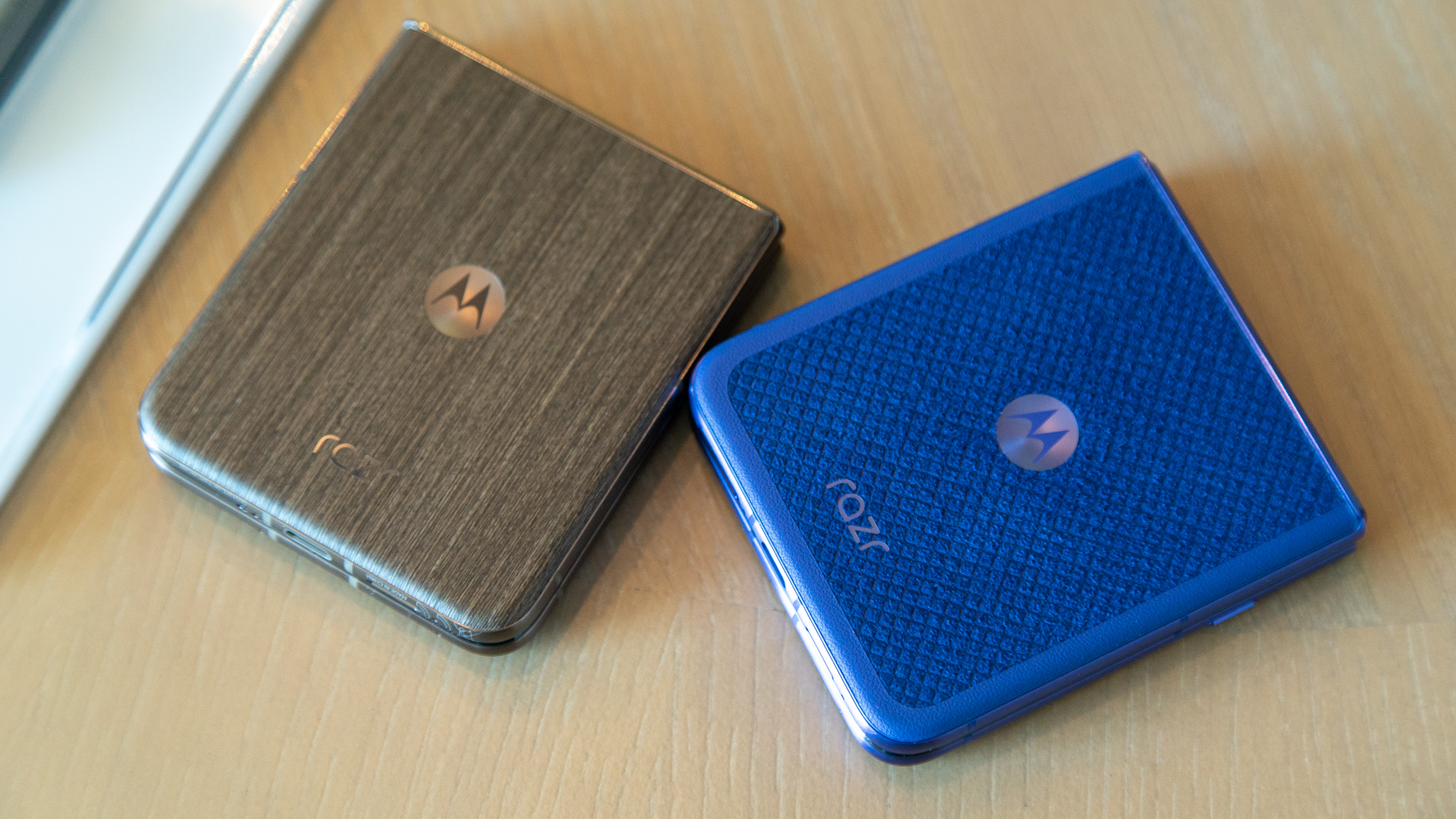 Close-up of the Motorola Razr 2026 available in different back-panel materials including soft-touch leather and wood finishes.