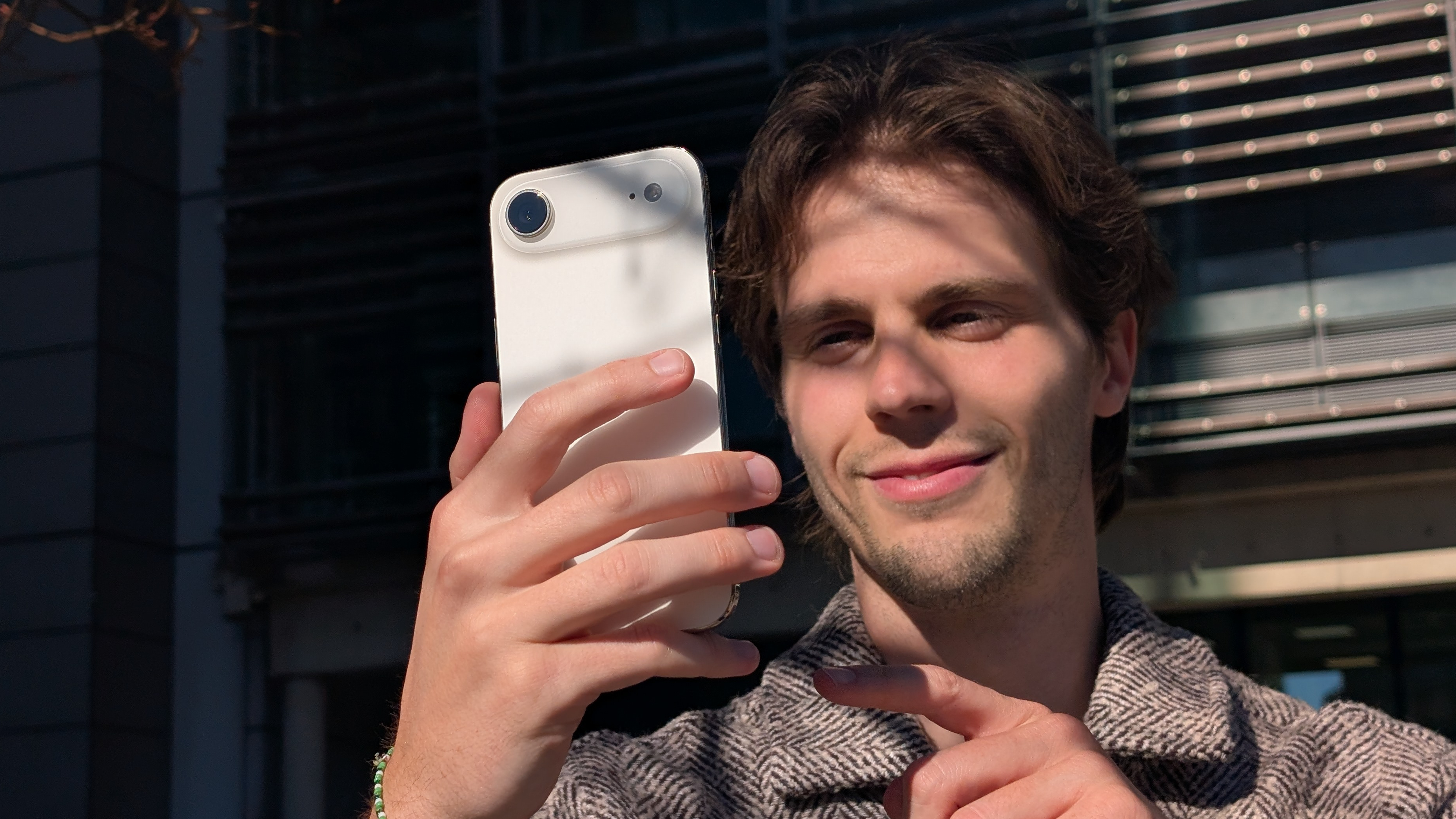 A person comfortably holding the lightweight iPhone Air in one hand.