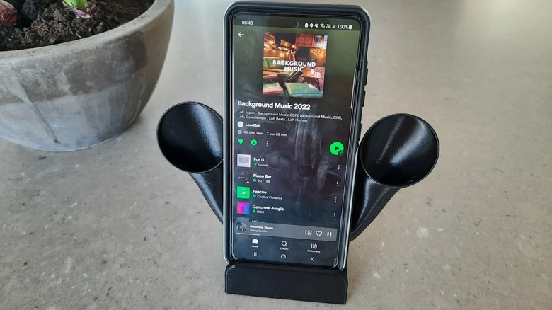 A smartphone resting on a 3D-printed acoustic sound amplifying stand.