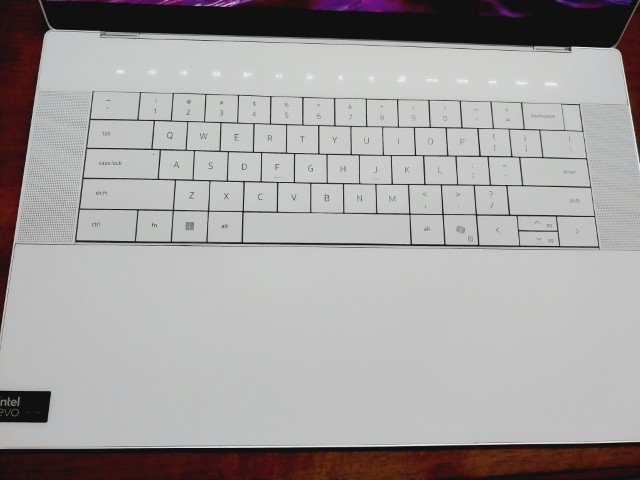 Close-up of the Dell XPS 16 9640 zero-lattice keyboard and the seamless glass palm rest that hides the haptic touchpad.
