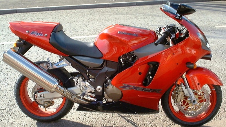 A red 2004 Kawasaki Ninja ZX-12R in a studio setting.
