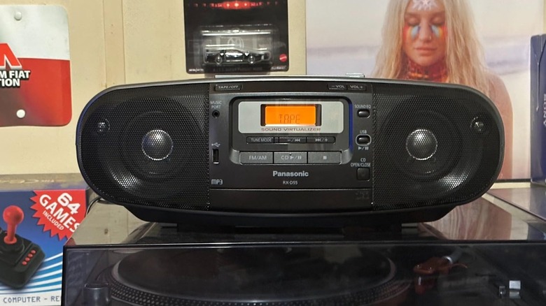 A large black Panasonic RX-D55GC-K boombox placed on top of a vinyl record player setup.