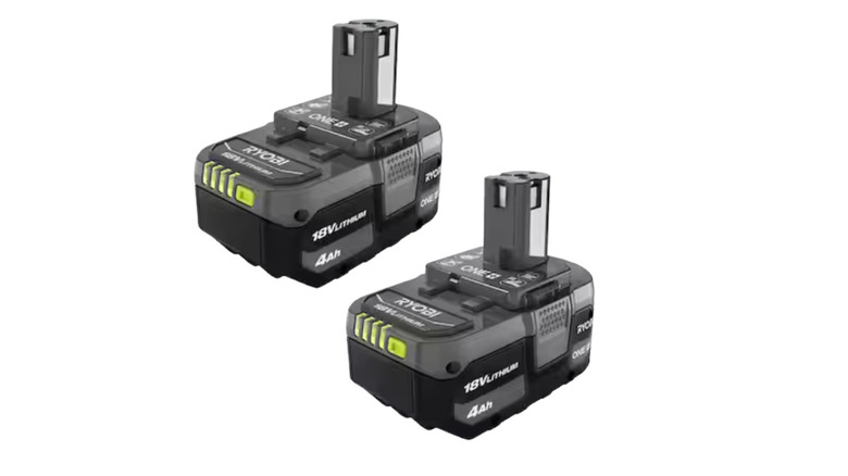 A close-up of a Ryobi One+ 18V lithium-ion battery.