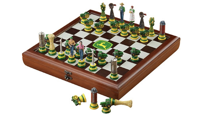 John Deere Heirloom Chess Set featuring tractors and silos as playing pieces on a wooden board.