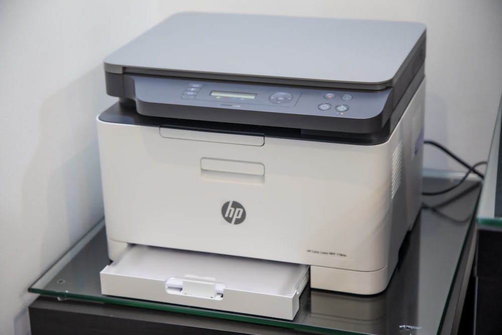 A modern multi-function printer in a corporate office environment.