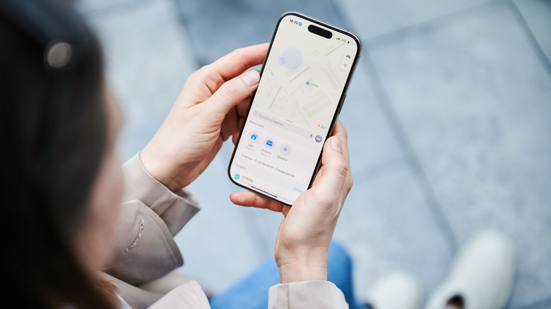 Close-up of a user interacting with an iPhone 16 which is designed for a long software lifespan.