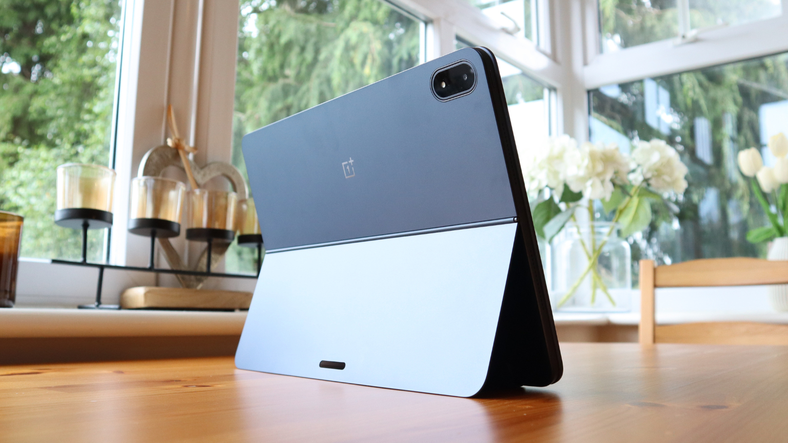OnePlus Pad 3 in a protective folio keyboard case on a wooden surface.