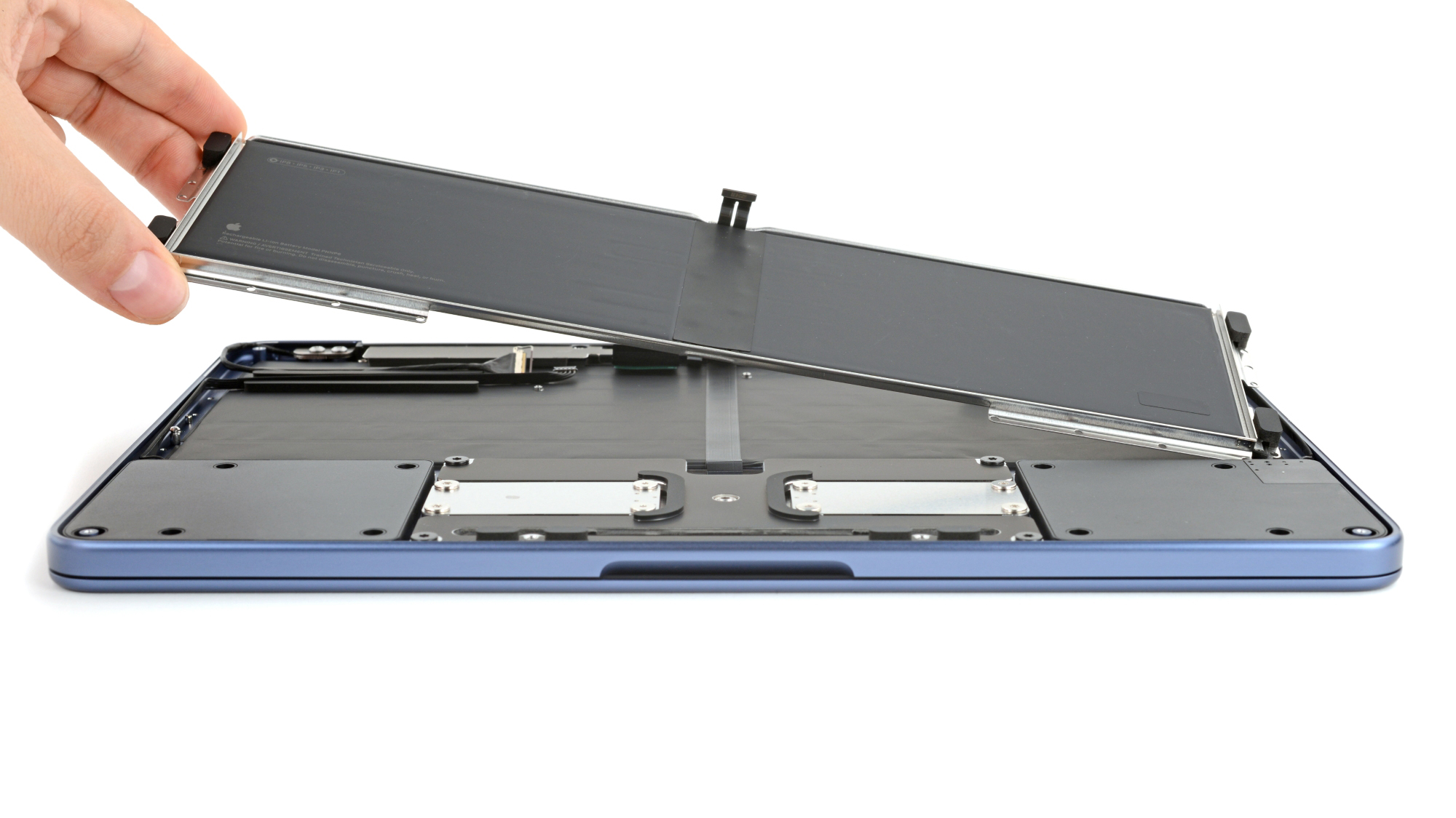 Close-up of the MacBook Neo battery tray secured by screws.