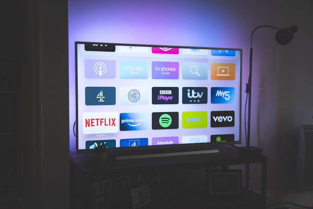 A large flat-screen television mounted on a wall in a modern living room.