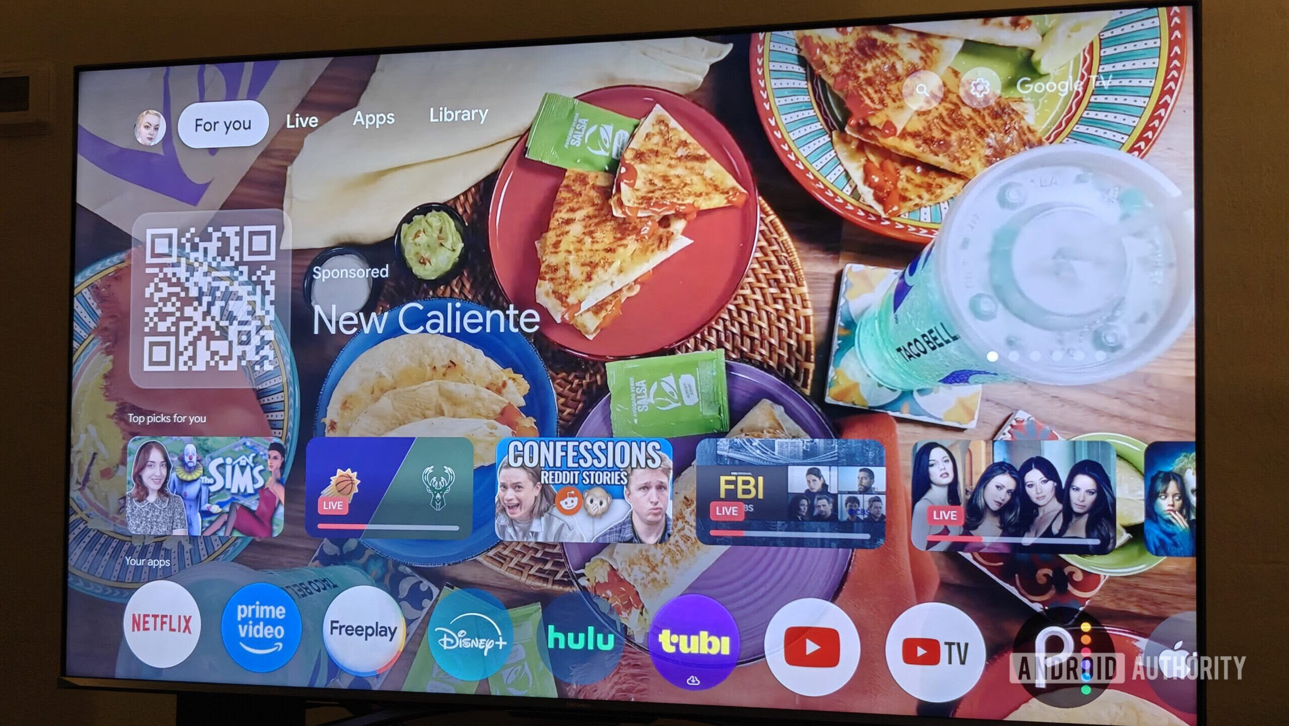 Stock Google TV home screen cluttered with sponsored movie banners and advertisements.