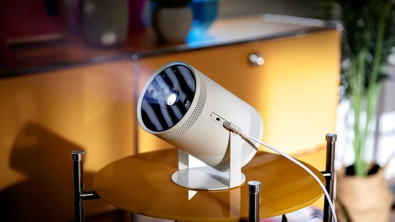 A compact Samsung The Freestyle portable projector in a modern living space.