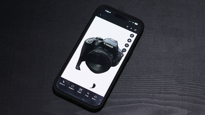 A digital 3D reconstruction of a vintage SLR camera within the Polycam app interface.