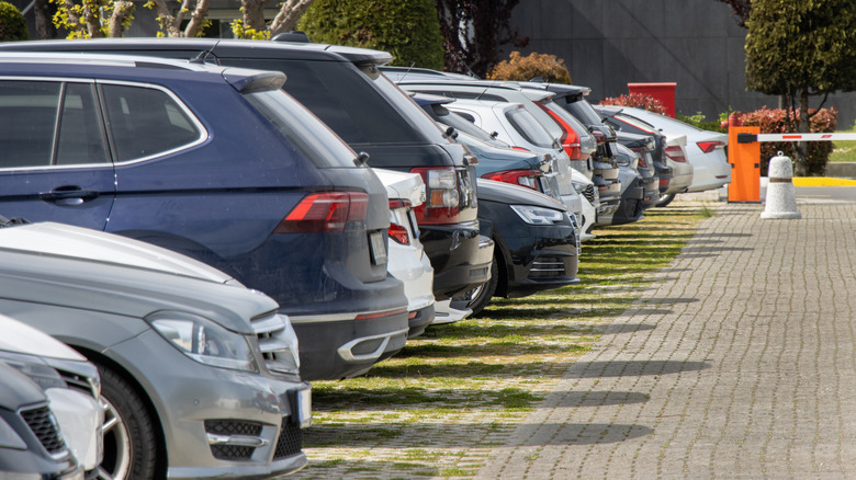 A high-angle view of a crowded outdoor parking lot with rows of parked cars.