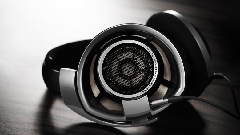 The Sennheiser HD 800 S open-back headphones lying on a wooden surface.