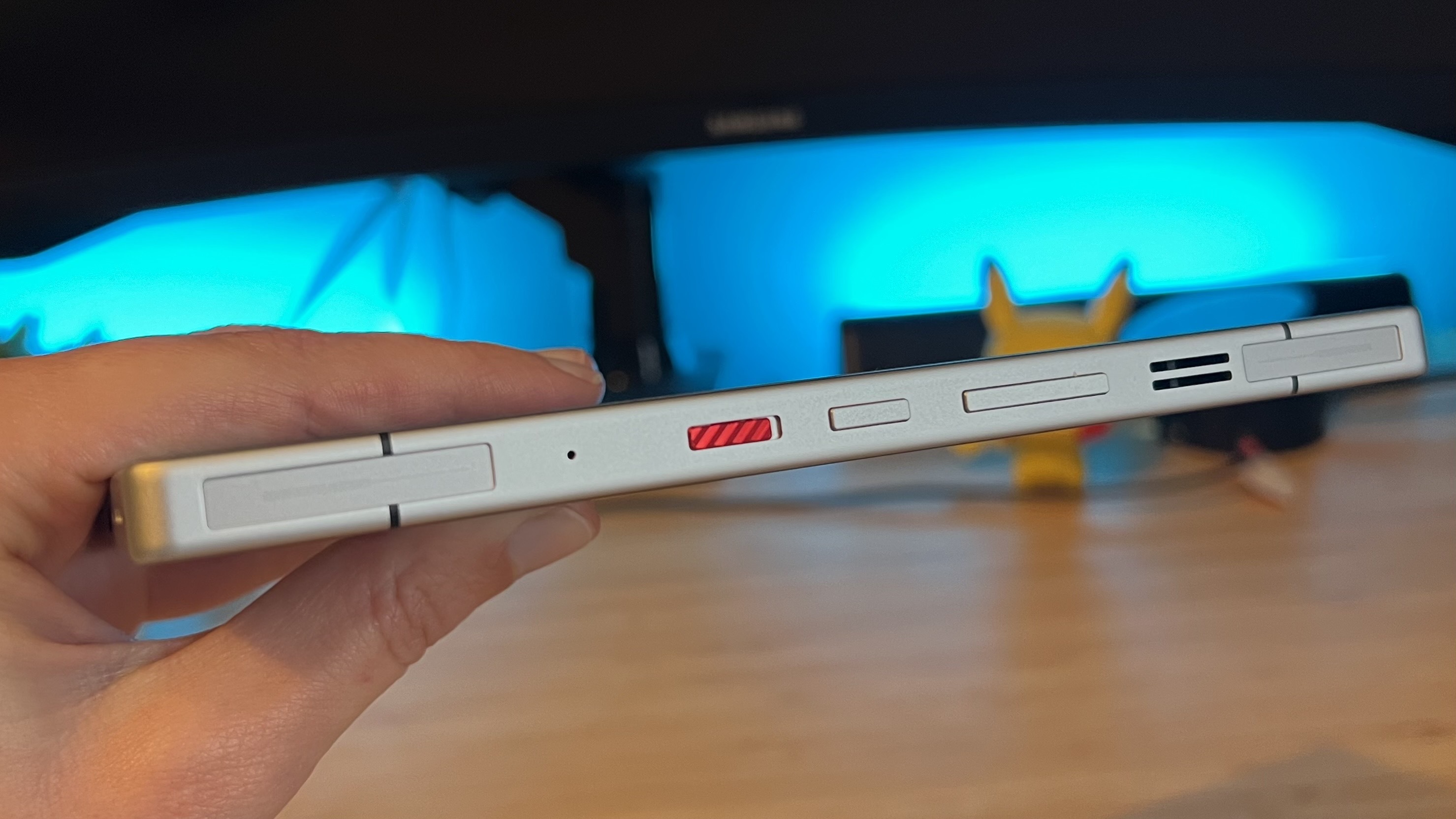 Close-up of a person's hands using the dedicated touch triggers on a RedMagic phone.
