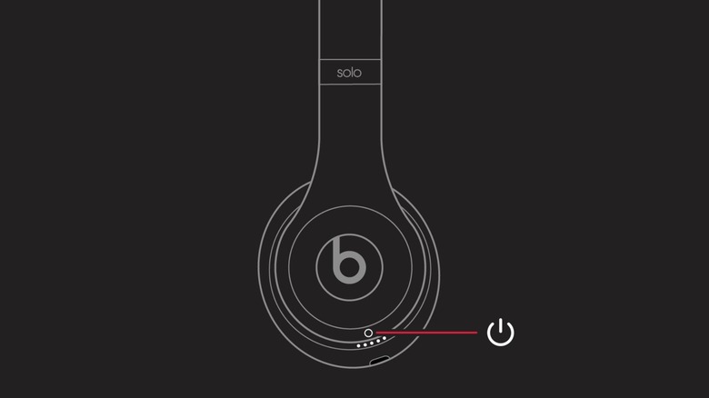 Close-up photo of the power button and status indicators on a pair of Beats Solo 3 headphones.