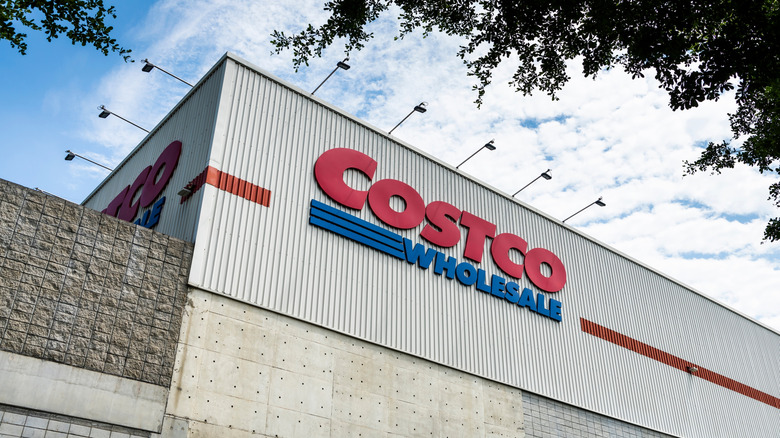 The exterior of a Costco Wholesale warehouse under a blue sky.