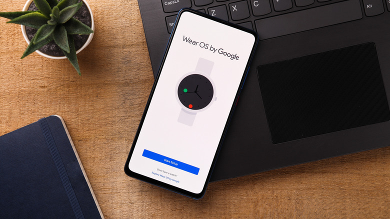 Google Wear OS branding displayed on a modern Android mobile device screen.