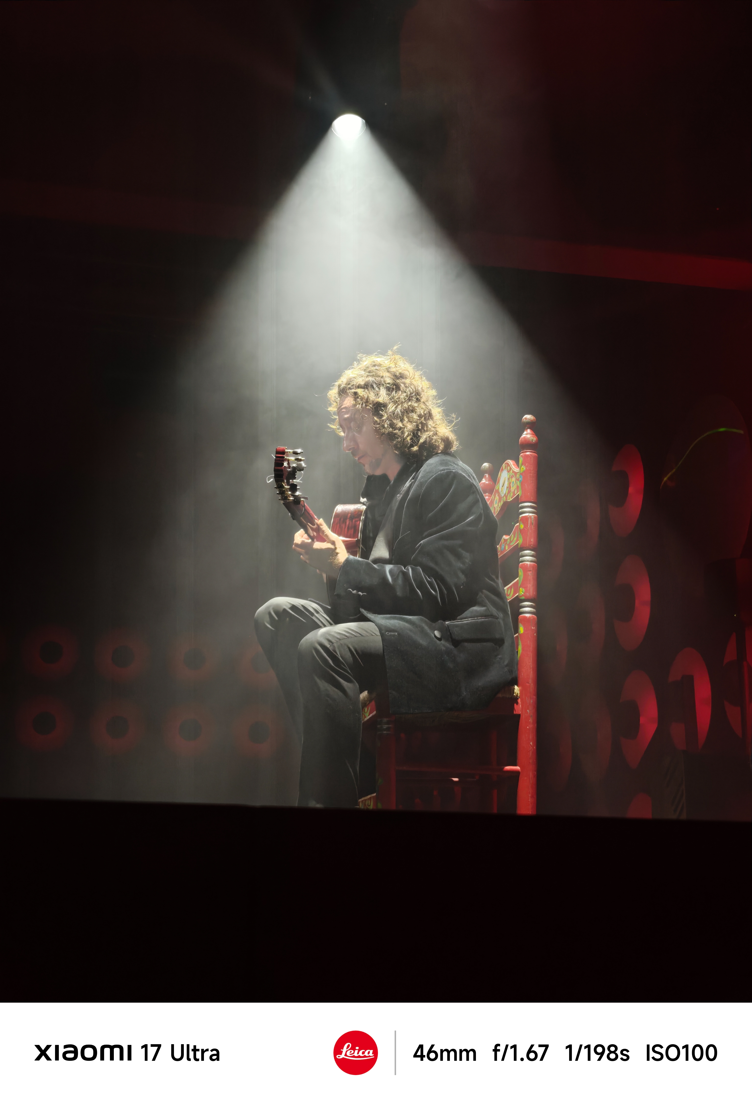 A low light photo of a flamenco guitarist showing excellent shadow detail and contrast.