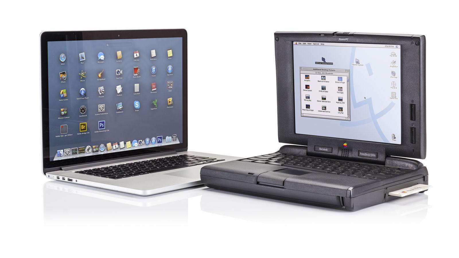 A stack of several generations of silver MacBook Pro and Air laptops.