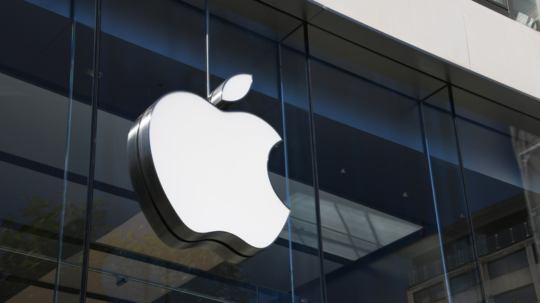 The iconic Apple logo displayed on a glass building facade.