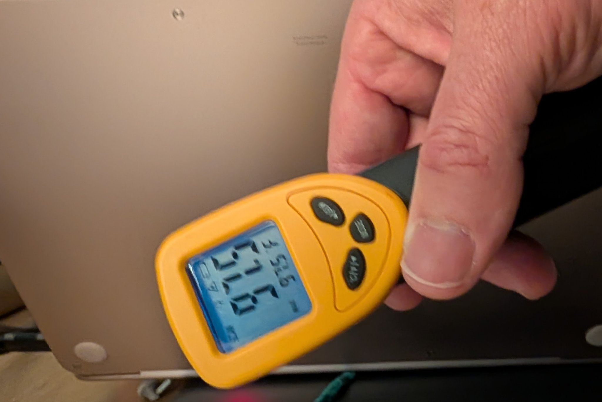 An infrared thermal camera view of a laptop chassis showing heat concentration areas.
