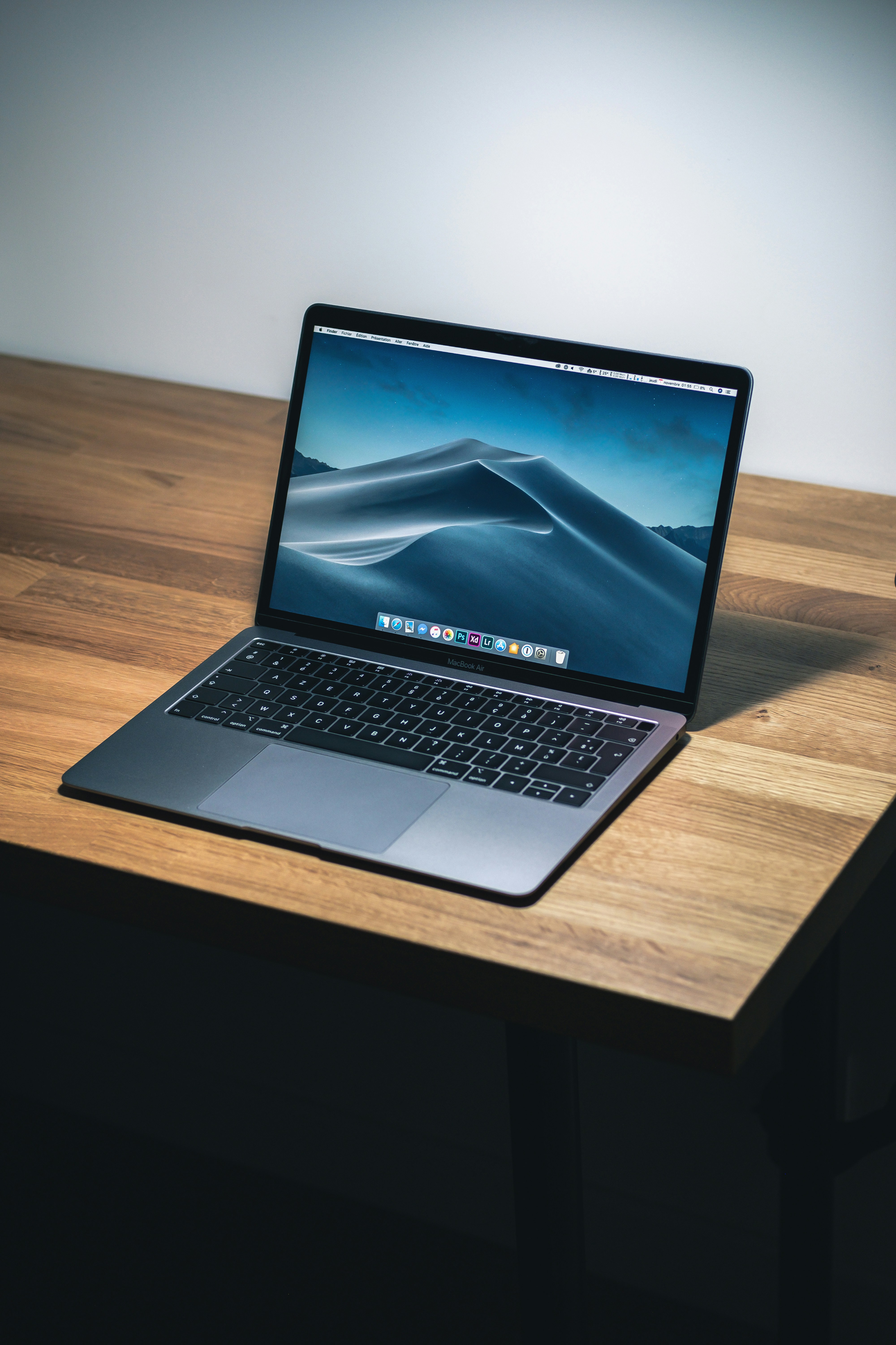 Macro shot of a MacBook Pro keyboard and trackpad showing the mechanical details.