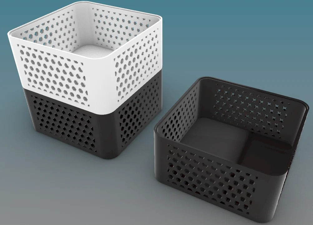 Several 3D printed stackable storage baskets in vibrant colors with a geometric mesh design.