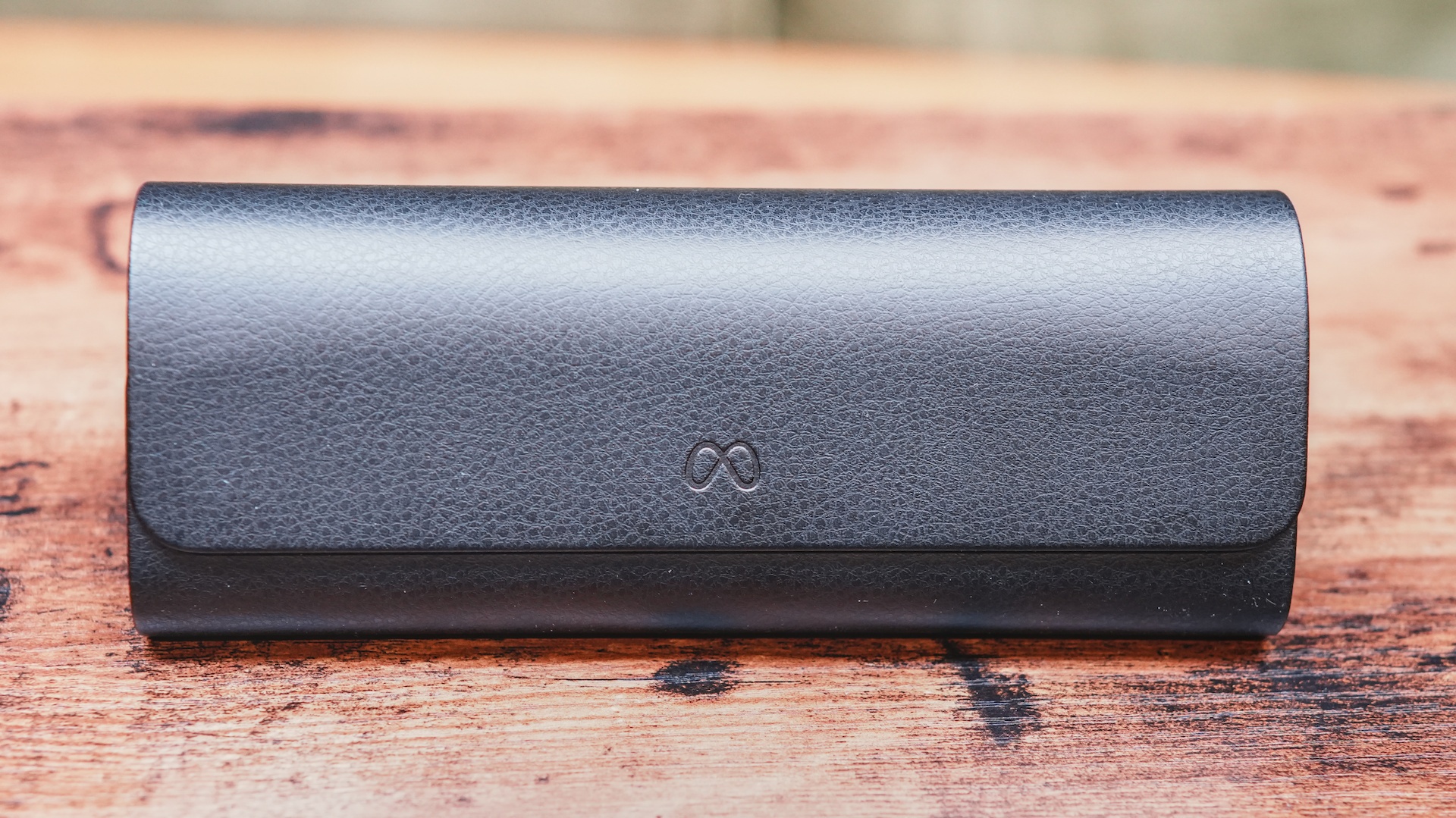 The Meta Ray-Ban Display glasses stored inside their brown faux-leather charging case.