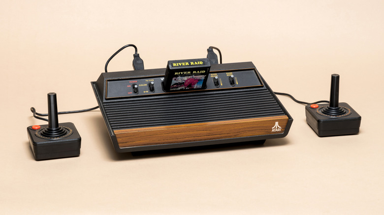 A vintage Atari 2600 console with a River Raid game cartridge inserted.
