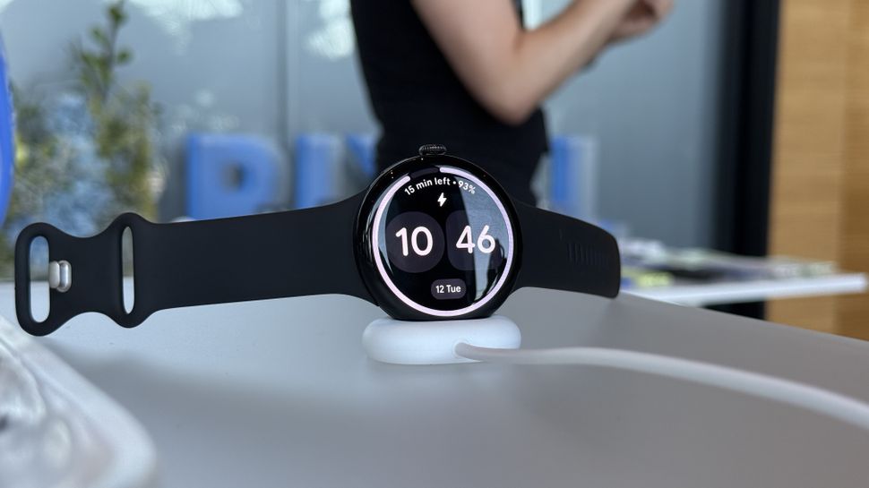 Google Pixel Watch 4 on a charging stand during initial setup.