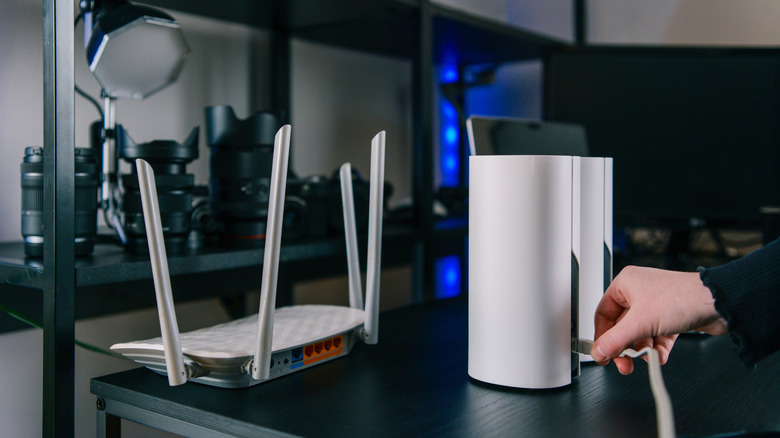 A comparison between a traditional Wi-Fi router and a compact mesh Wi-Fi satellite unit.