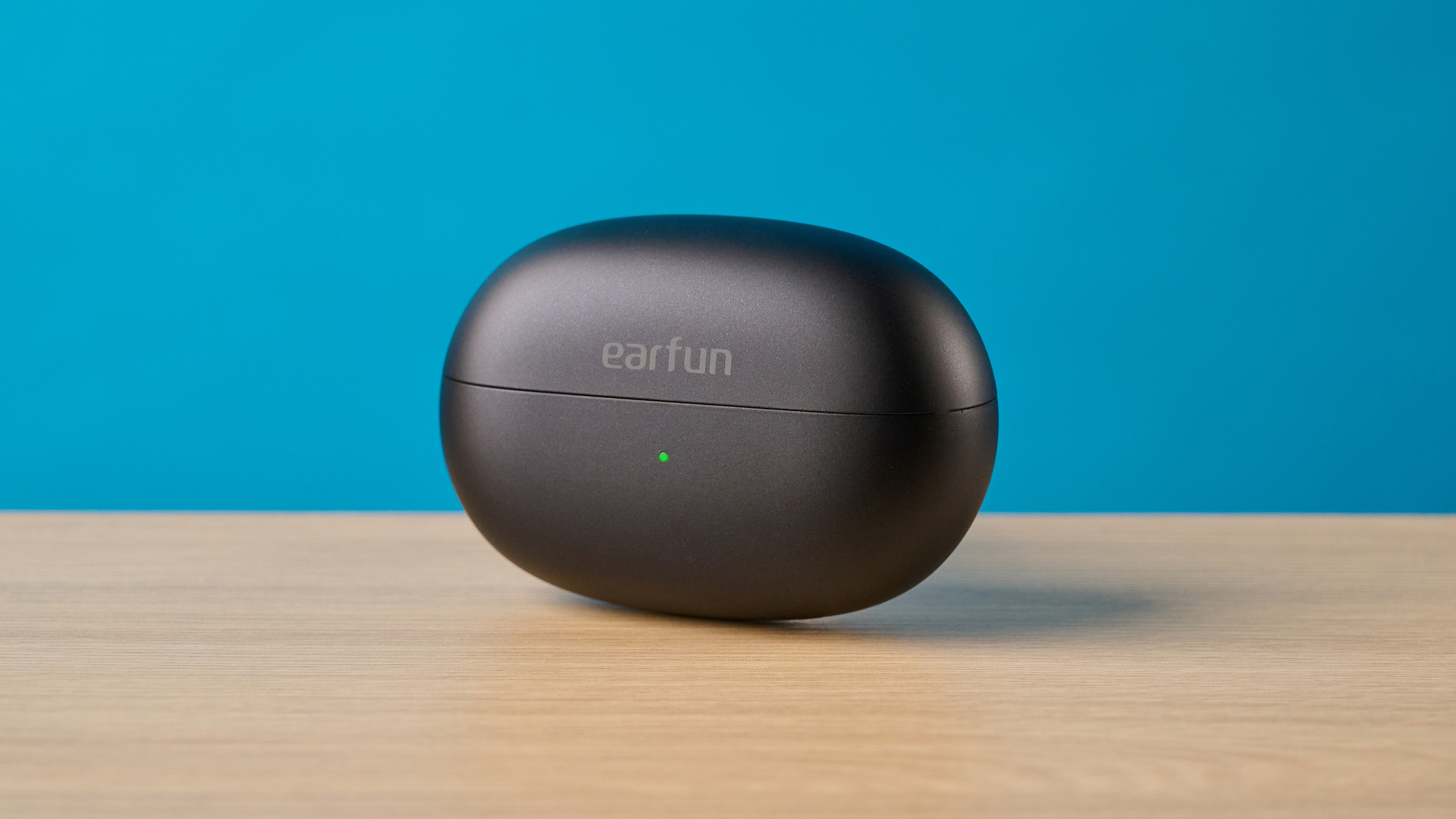 EarFun Clip 2 earbuds displayed against a solid blue background