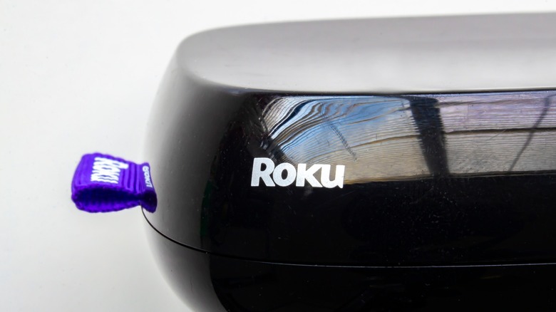 A side view of a Roku streaming device showing its compact design.