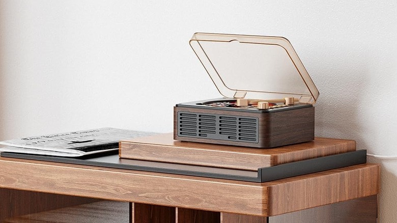A walnut-finish Caronsoft CD player with integrated speakers on a shelf.