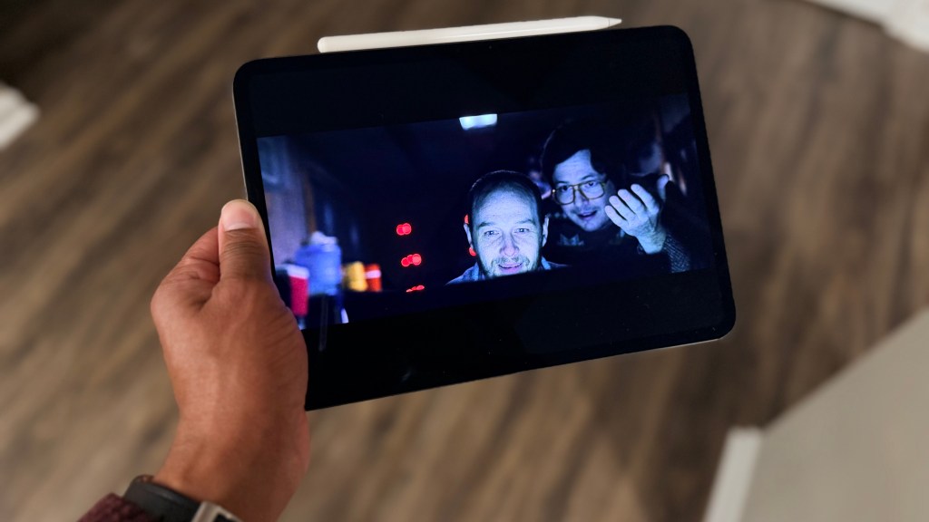 A person watching a high-definition video on the M5 iPad Pro OLED screen.