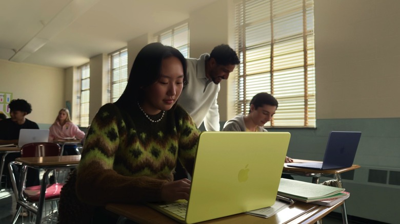 Group of students using their MacBook Neo laptops in a classroom setting.