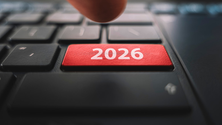 A close-up of a laptop key labeled 2026 being pressed.