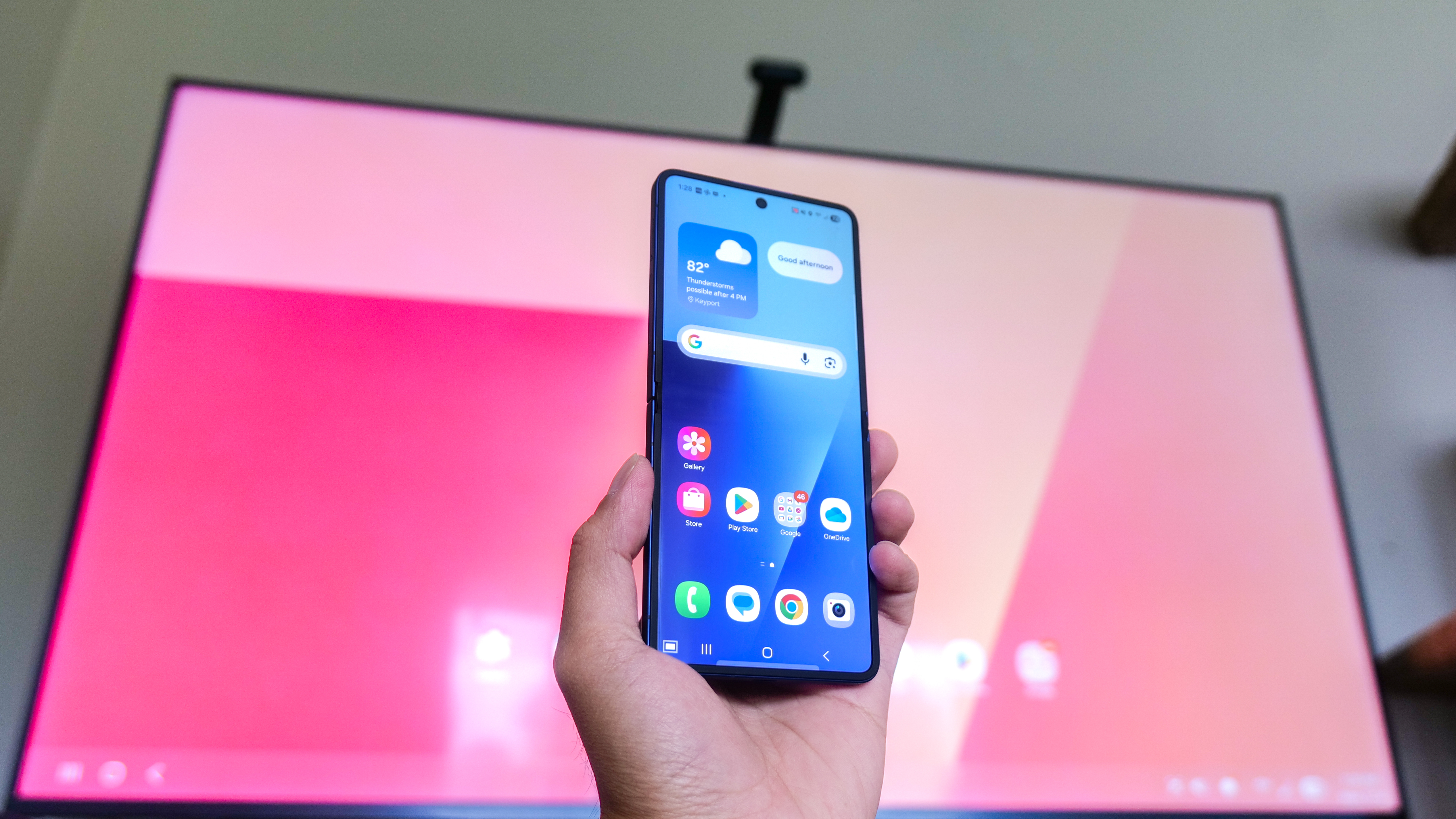 A Galaxy Z Flip 7 connected to an external monitor showing the DeX interface.