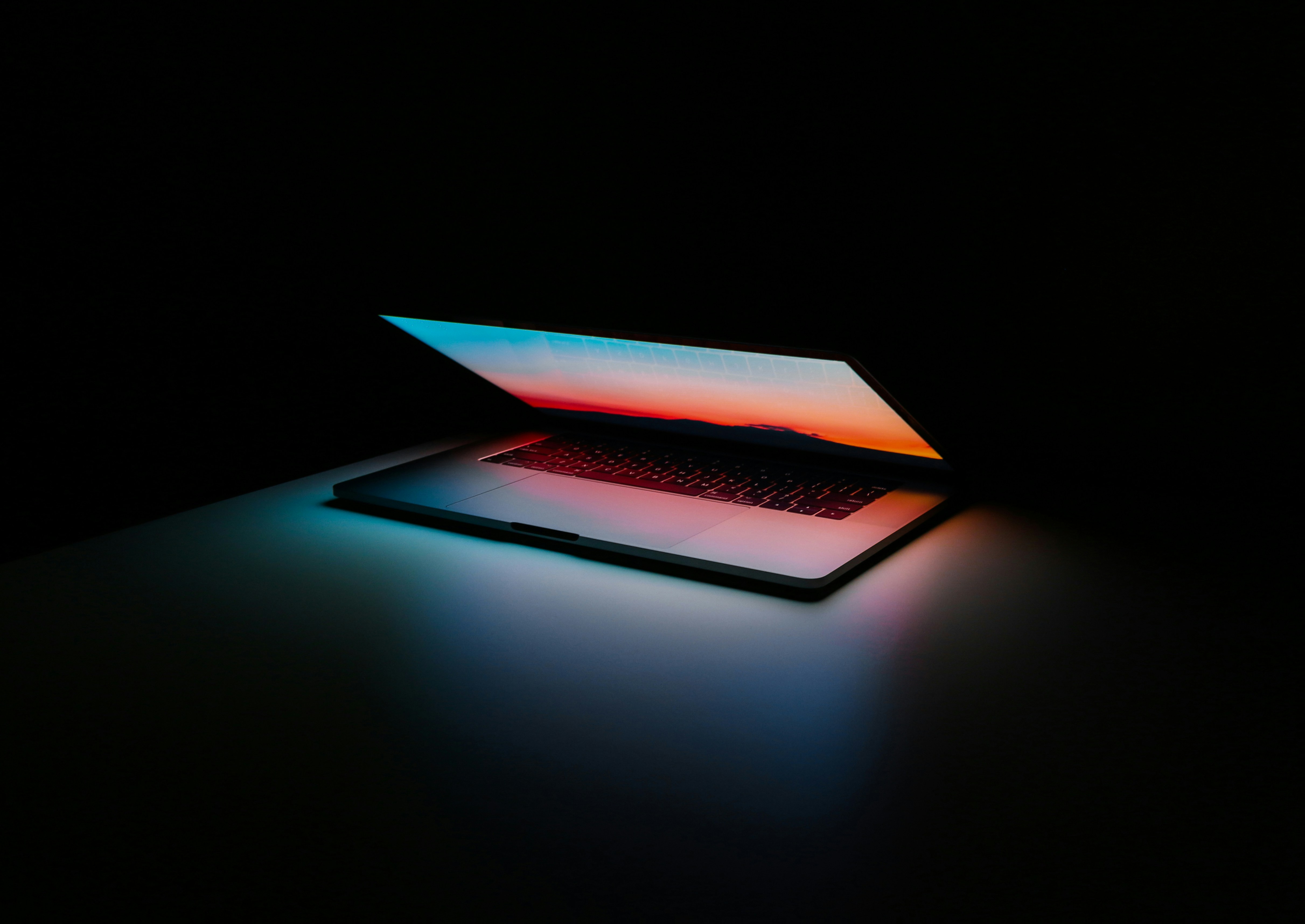 Close-up detail of the smooth aluminum edge and hinge of a MacBook Pro.