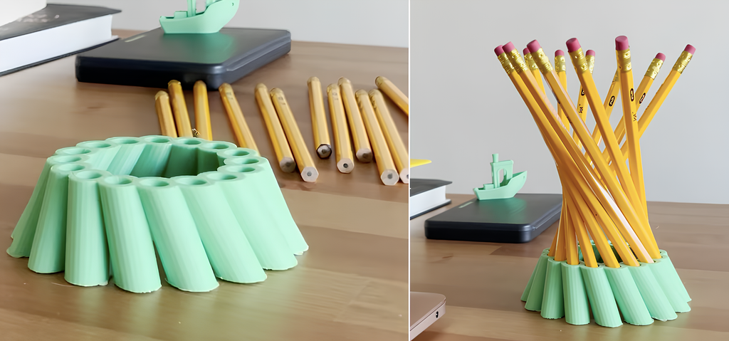 A white 3D printed pen holder with a complex hyperboloid geometric structure holding several pencils.