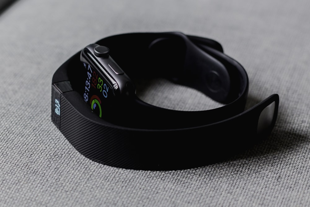 A close-up of a person wearing a smartwatch tracking heart rate data.