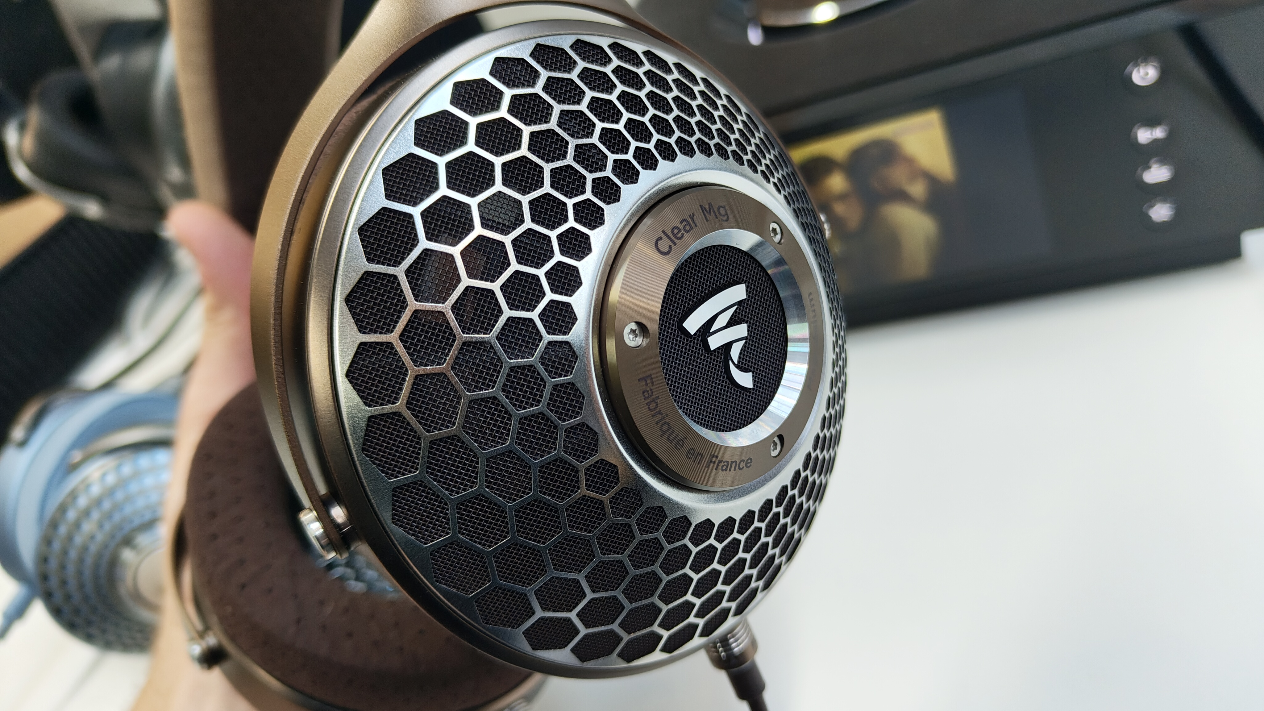 A close-up of the Focal Clear Mg headphones featuring magnesium driver grilles.