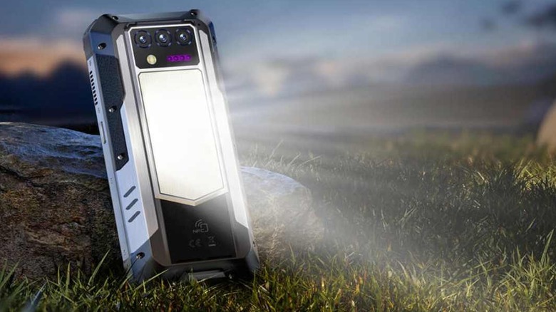 The Oukitel WP100 Titan rugged phone with its integrated high-lumen camping light illuminated.